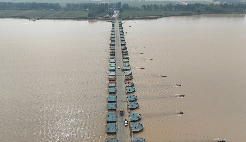 “秋收”農(nóng)用車經(jīng)過黃河浮橋。曹金磊攝